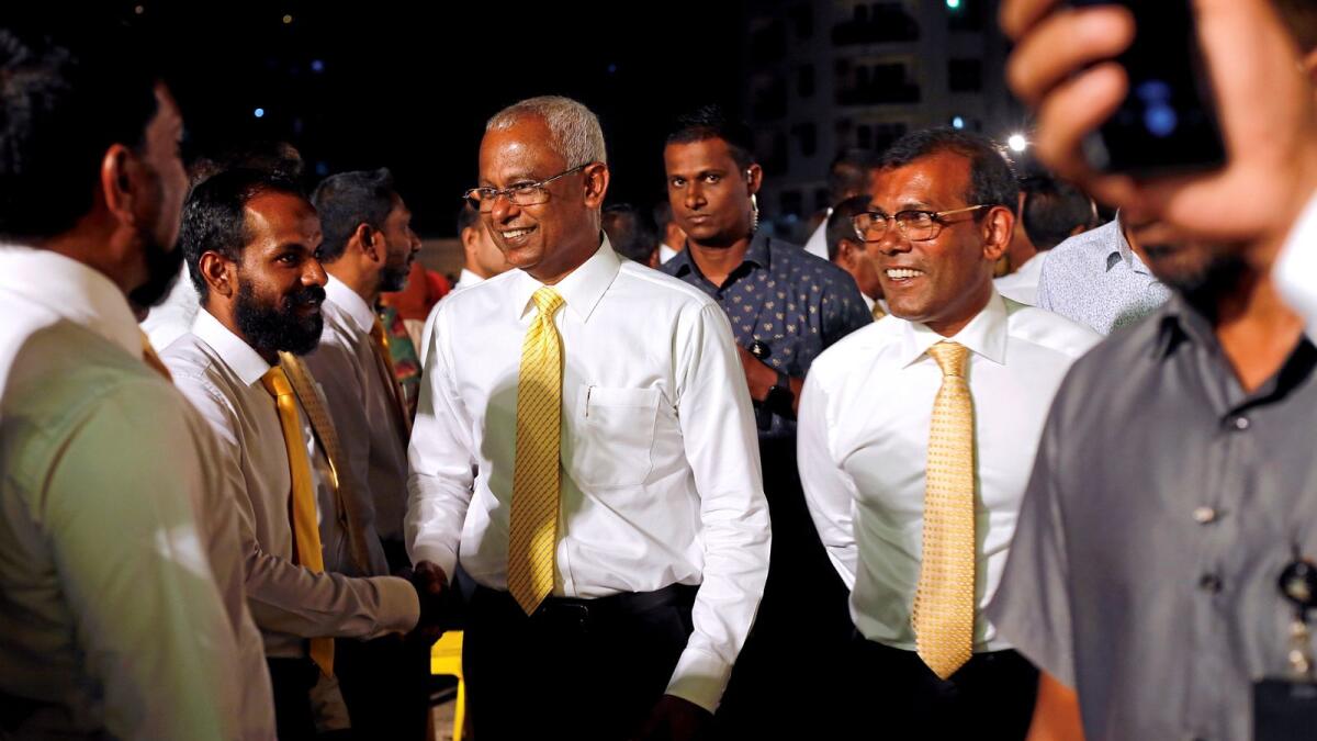 Maldives President Ibrahim Mohamed Solih and former president Mohamed Nasheed arrive at an election campaign rally.