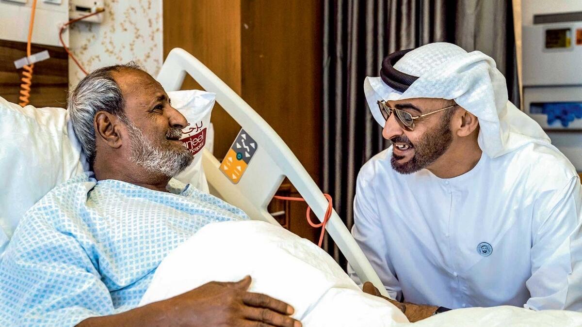 Sheikh Mohamed bin Zayed shares a light moment with Fadel Mahmoud Saleh, who is in Abu Dhabi receiving medical assistance at Burjeel Hospital. — Wam file