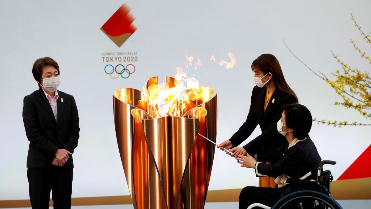 Tokyo 2020 President Seiko Hashimoto looks on as actor Satomi Ishihara and Paralympian Aki Taguchi light the celebration cauldron on the first day of the Tokyo 2020 Olympic torch relay in Naraha, Fukushima prefecture. — Reuters