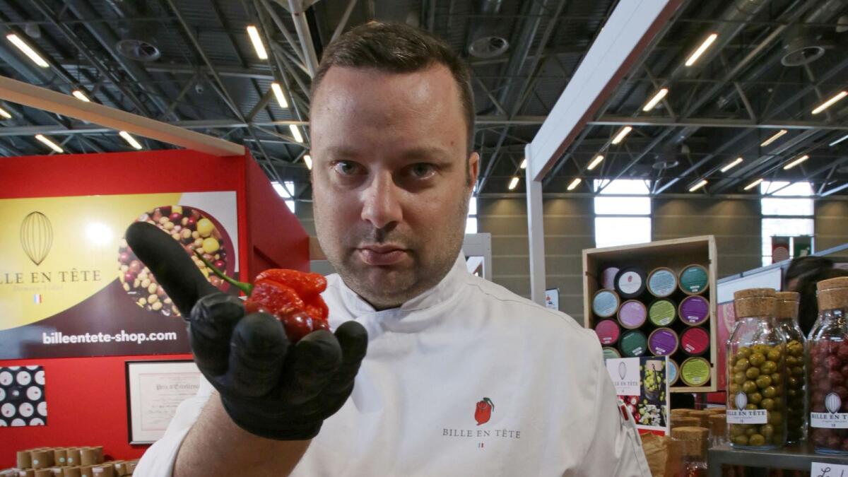 French chocolatier Damien Vidal poses with chocolates flavoured with Carolina Reaper chilli pepper at the Paris Chocolate fair in Paris, France, on Friday. —Reuters