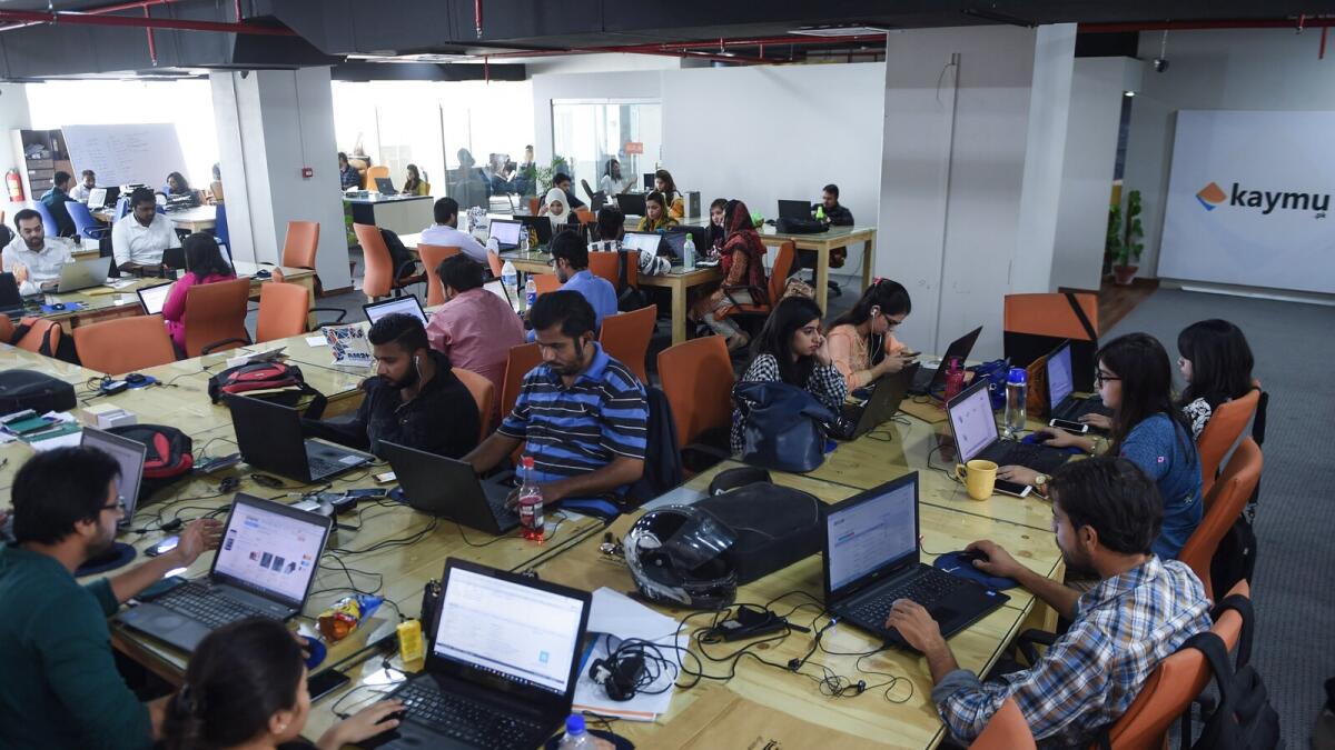 Employees of online marketplace Kaymu work in Karachi. Such firms are bridging the gap between local businesses in Pakistan and a global audience. — AFP