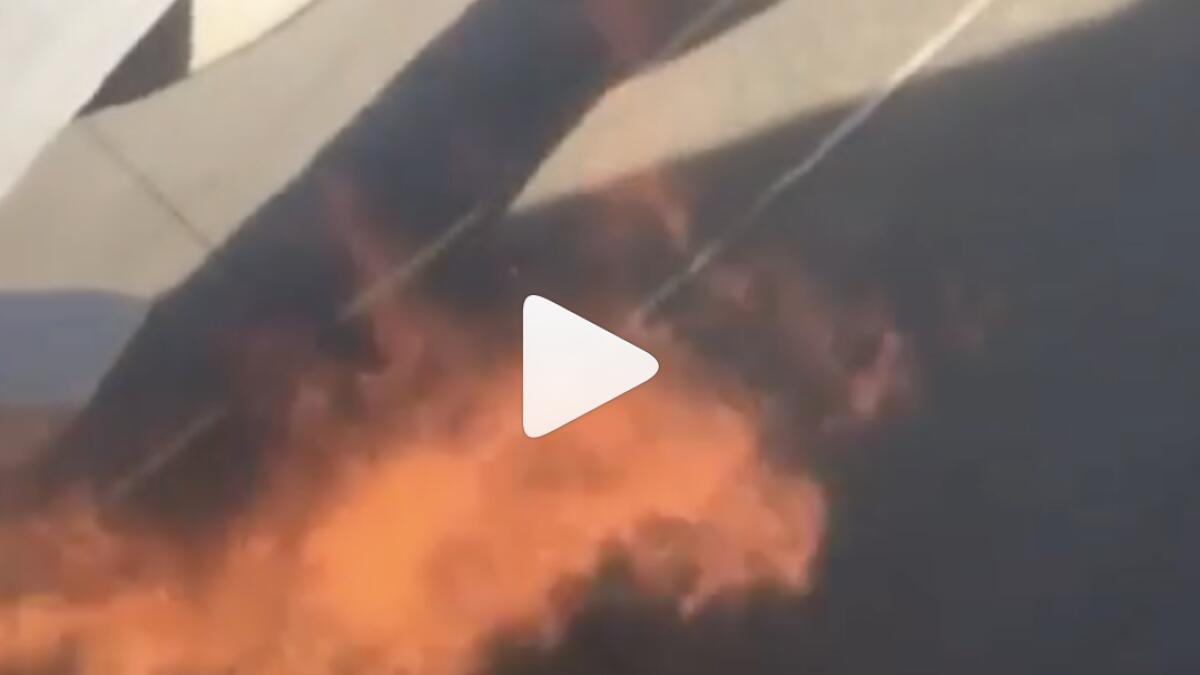 Video: Plane engine catches fire, passengers jump onto wing