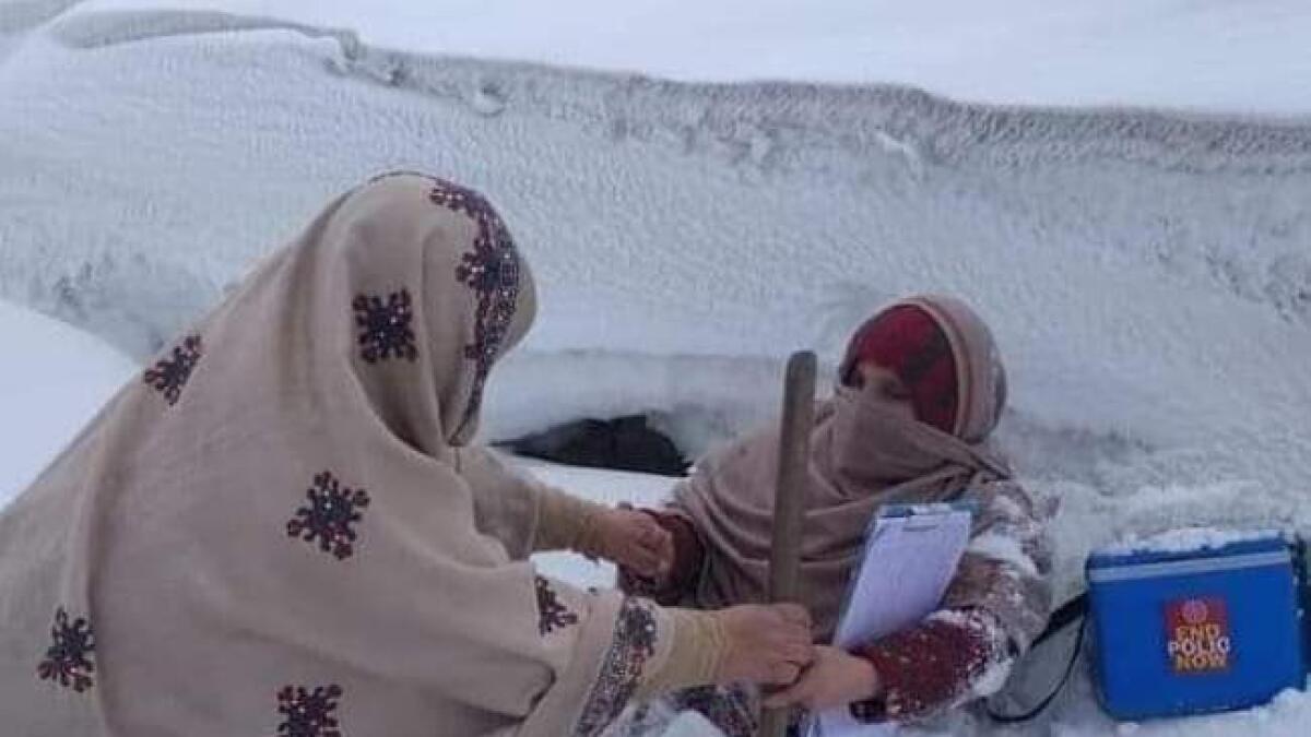 Photos: Pakistani female polio workers battle heavy snow during campaign