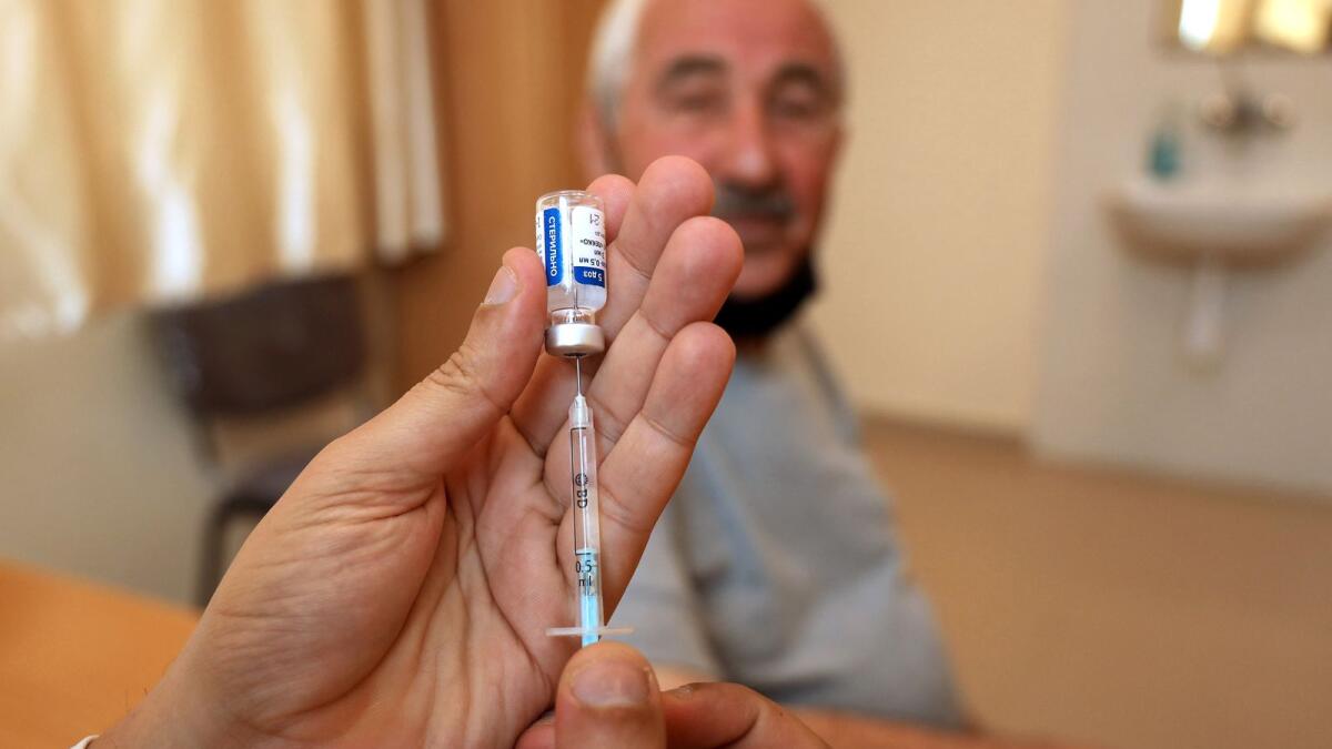 An elderly man waits to receive a dose of Covid-19 vaccine in Gaza City. — AFP file