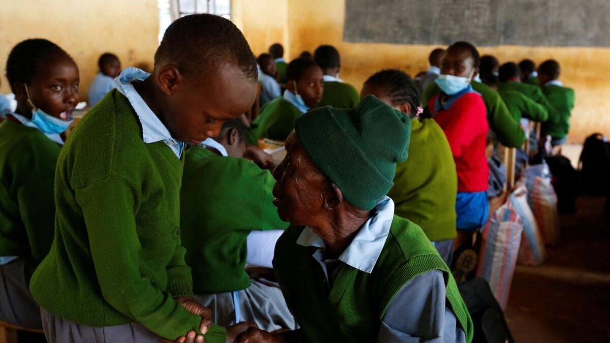 Priscilla Sitienei greets her 6th Grade schoolmate at the Leaders Vision Preparatory School in Ndalat village of Nandi County, Kenya, in this Reuters file photo.