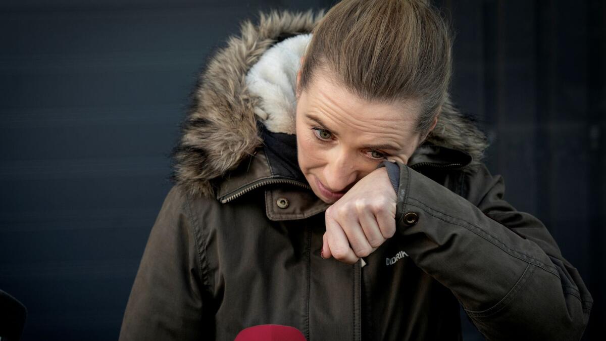 Denmark's Prime Minister Mette Frederiksen reacts after a visit to an empty Mink Farm near Kolding in Denmark.