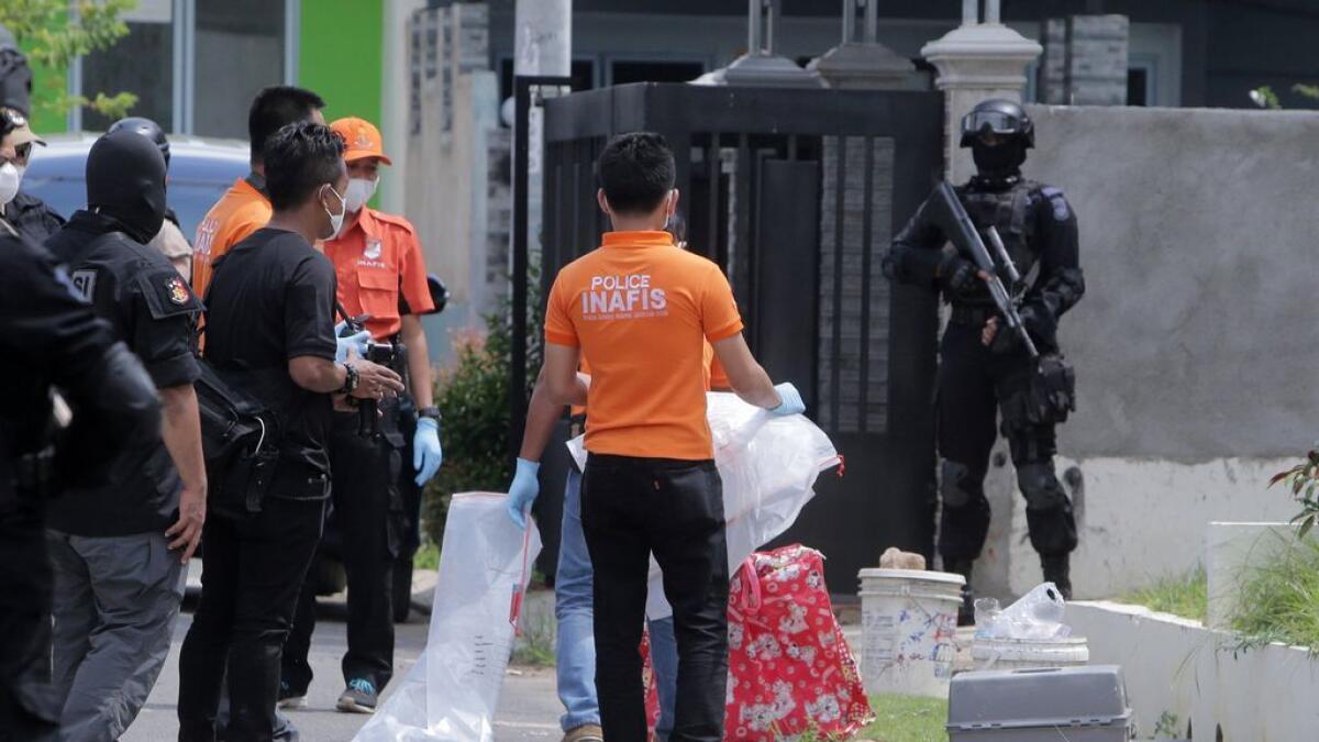 Indonesian anti-terror police and an identification team are seen outside a building during a raid in Batam, Riau Islands, Indonesia