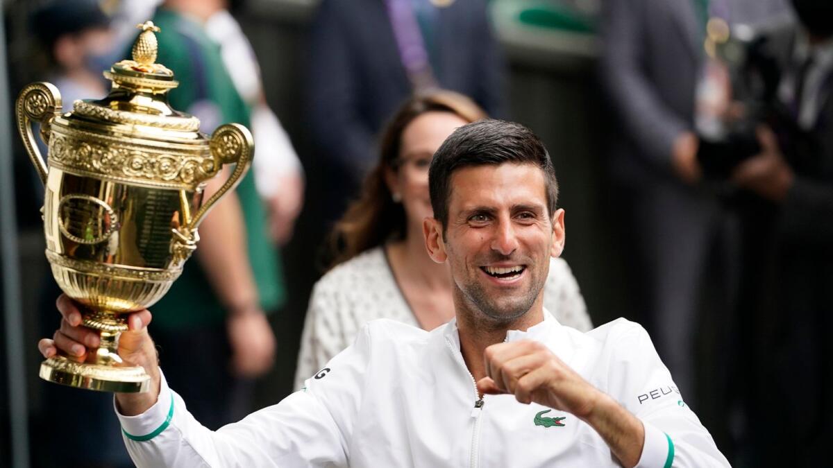 Serbia's Novak Djokovic holds the winner's trophy after his victory over Italy's Matteo Berrettini during the Wimbledon final. — AP