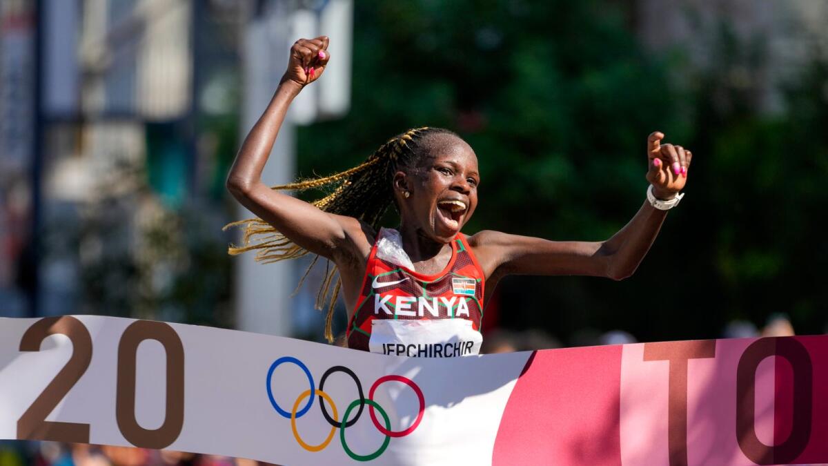 Peres Jepchirchir of Kenya celebrates as she crosses the finish line to win the women's marathon at the 2020 Summer Olympics. — AP