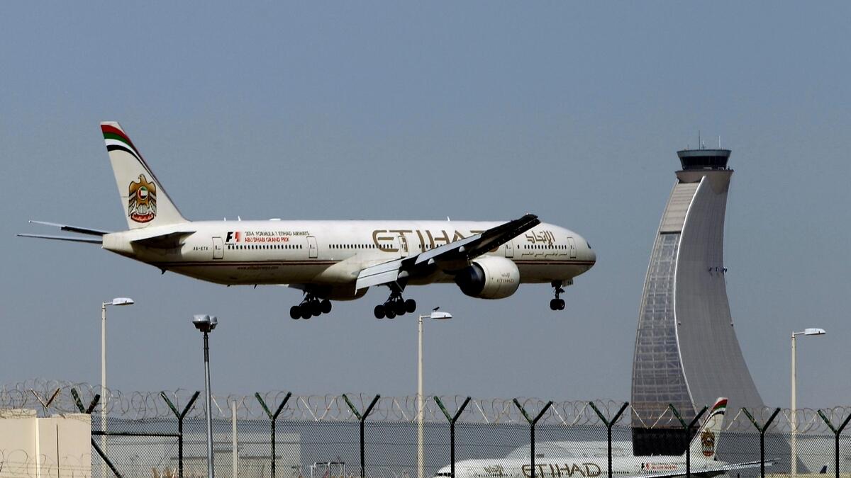 An Etihad Airways plane prepares to land at the Abu Dhabi airport in UAE.-AP file photo