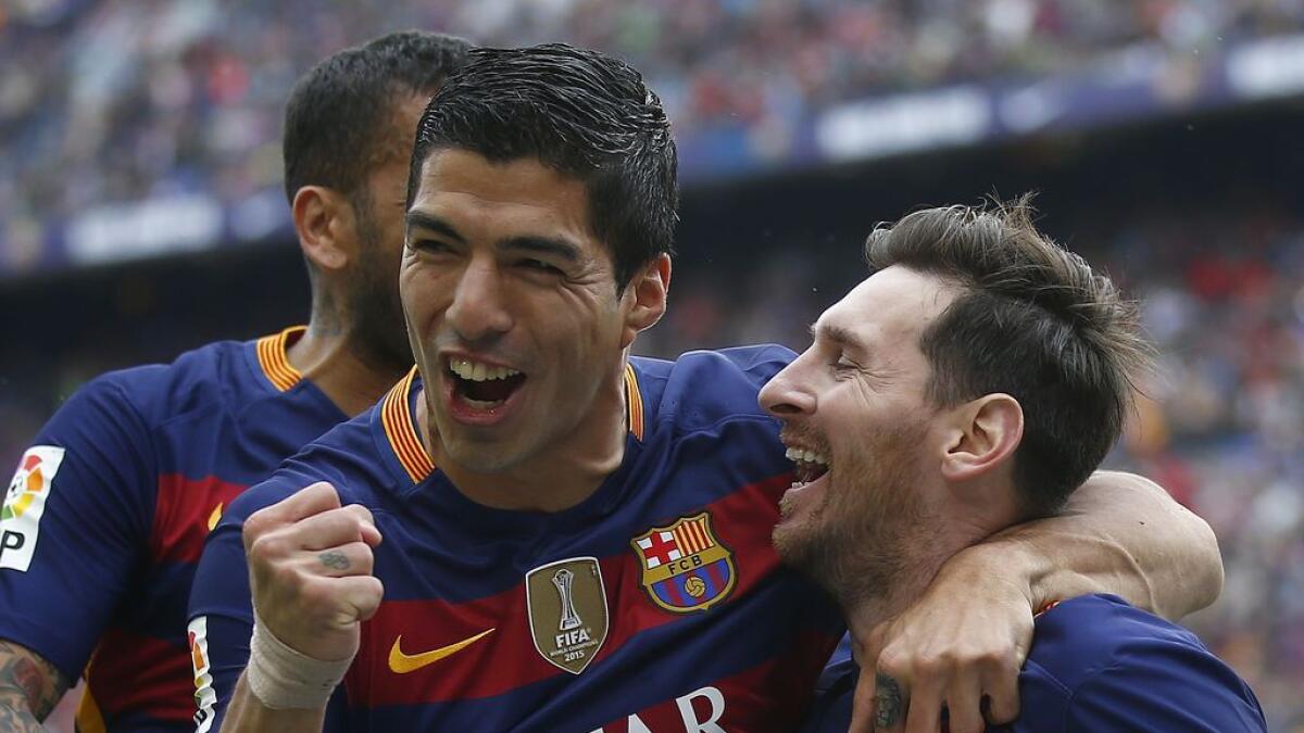 Hat-trick hero Suarez leads Barca to La Liga title