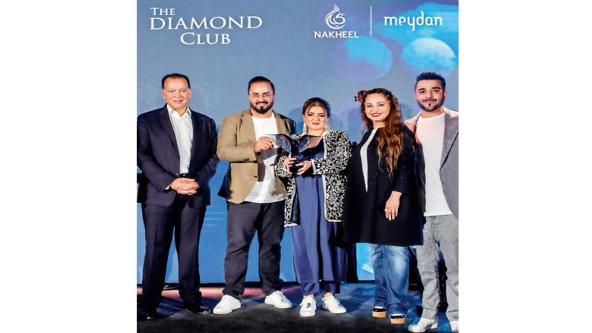 Qurat Ul Ain and Mudasir Wani, founders of Drehomes Real Estate receive an award from Rasha Hassan, CCO at Nakheel, and Naaman Atallah, CEO at Nakheel for smashing sales.