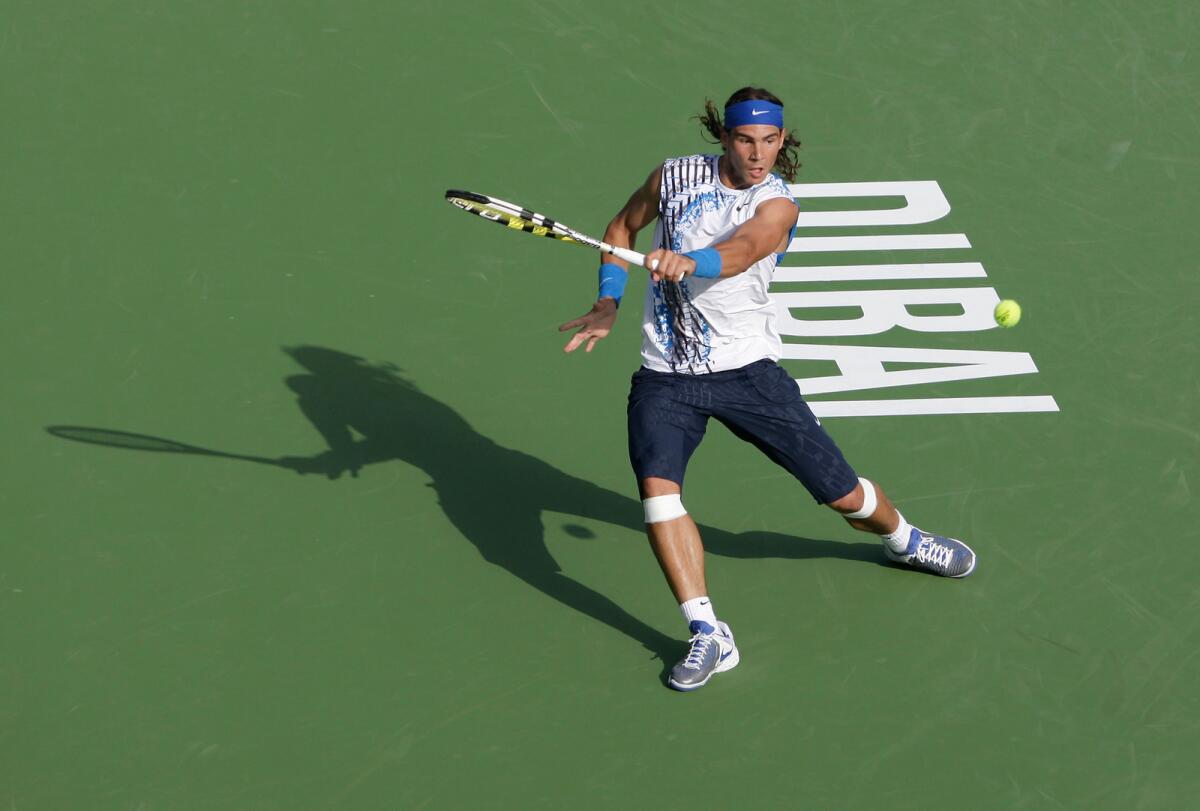 Nadal hits a return at the Dubai Tennis Championships in 2006