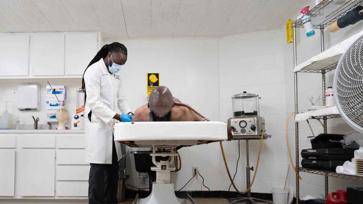 Shawn’te Harvell, who does nearly 50 embalmings a week, at work at the James Hunt Funeral Home in Asbury Park, New Jersey, on Oct. 27, 2022. Embalming has become a less common part of American funeral rituals as cremation and green burials have increased. (James Estrin/The New York Times)