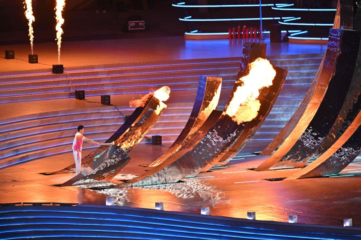 A torch bearer lights the Asian Games cauldron during the opening ceremony of the 2022 Asian Games at the Hangzhou Olympic Sports Centre Stadium in Hangzhou in China's eastern Zhejiang province on Saturday. - AFP