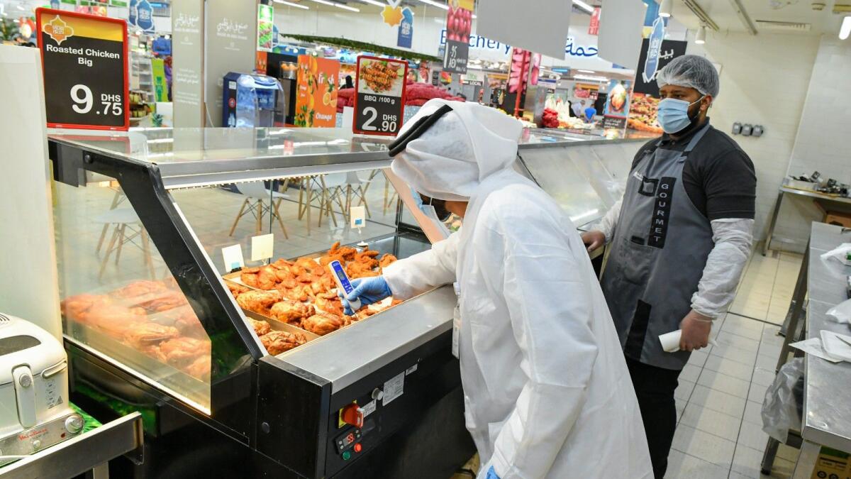 Abu Dhabi Agriculture and Food Safety Authority officials inspect a food establishment. — Wam