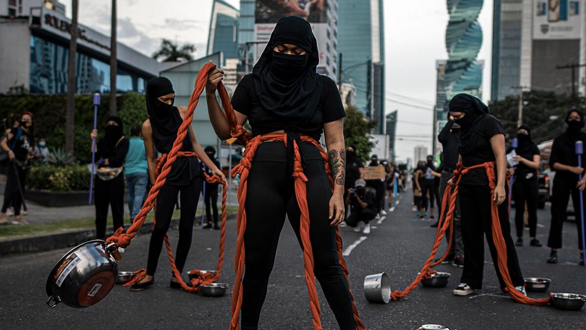 A group of women perform during a protest against the alleged corruption and the lack of measures with a gender perspective, amid the coronavirus pandemic in Panama City. Photo: AFP