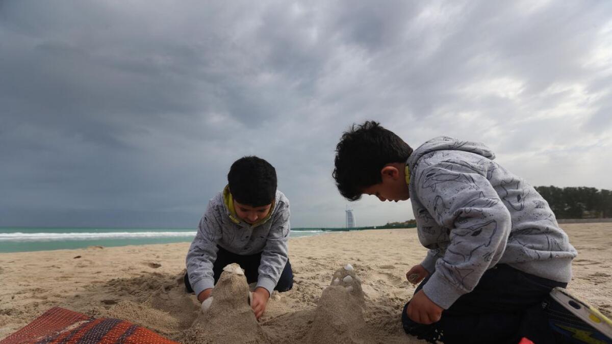 Kids enjoy the cloudy weather at the Black Palace Beach in Dubai. -Photo by Dhes Handumon/Khaleej Times