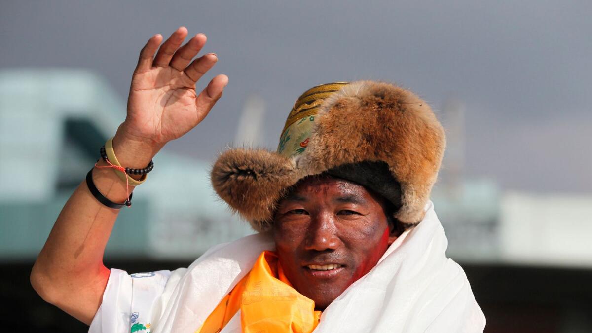 Nepalese veteran Sherpa guide Kami Rita waves as he arrives in Kathmandu, Nepal, May 20, 2018. -- AP file