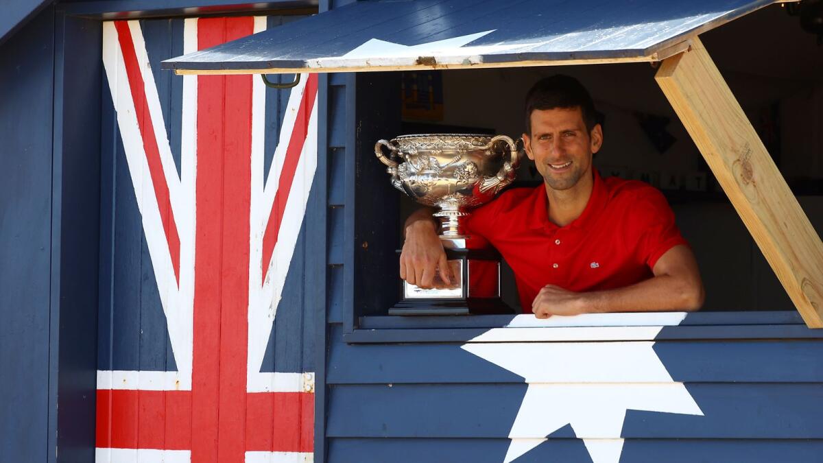 Serbia's Novak Djokovic poses with the Norman Brookes Challenge Cup trophy. — AFP