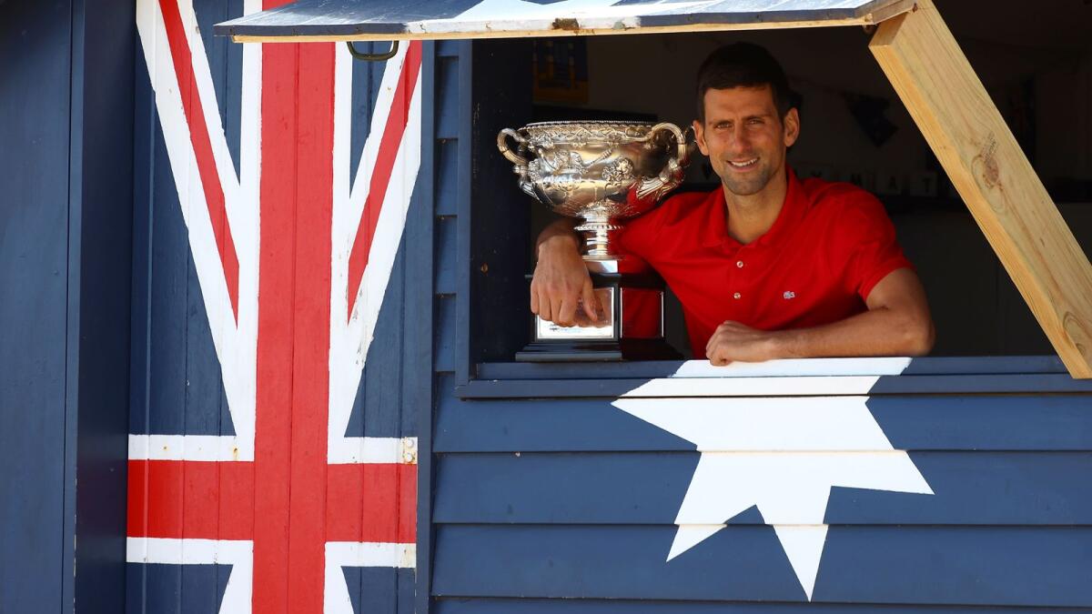 Serbia's Novak Djokovic poses with the Norman Brookes Challenge Cup trophy. — AFP