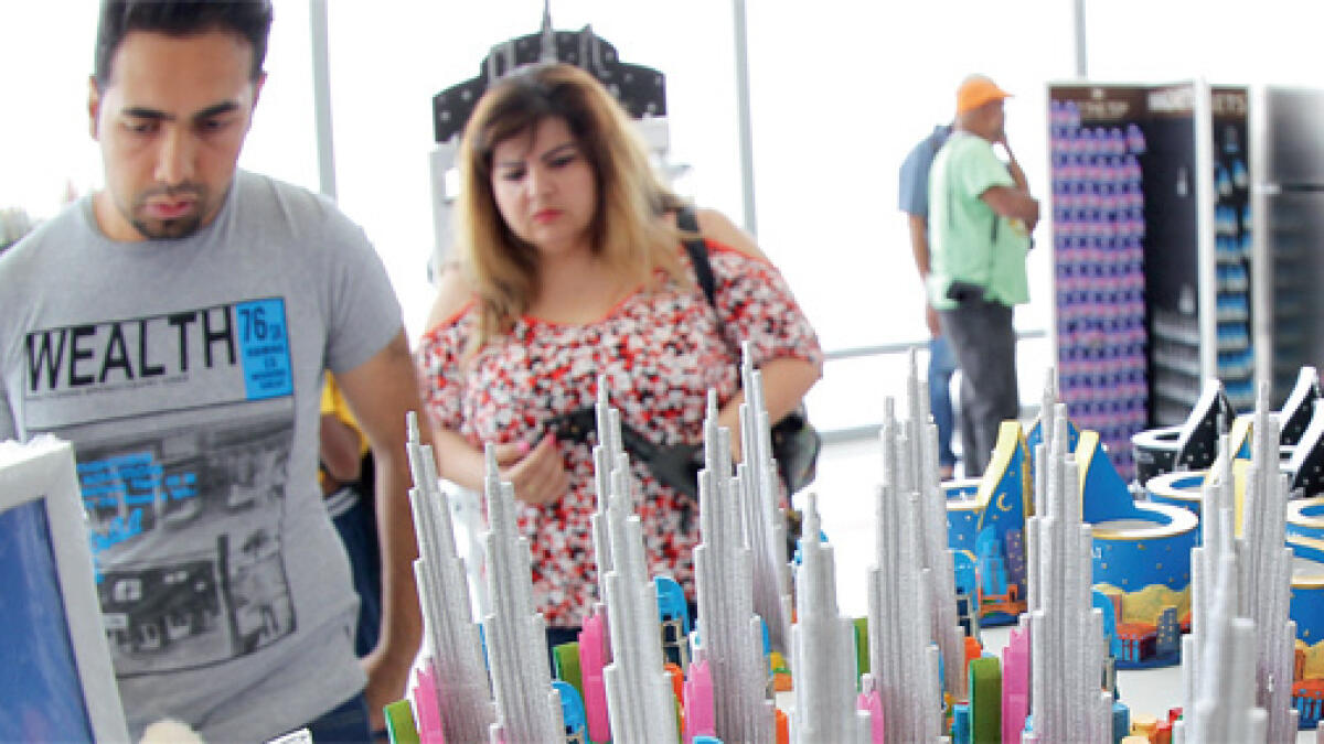 Shop at the top: Visitors look to buy souvenirs displayed At the Top, Burj Khalifa SKY.