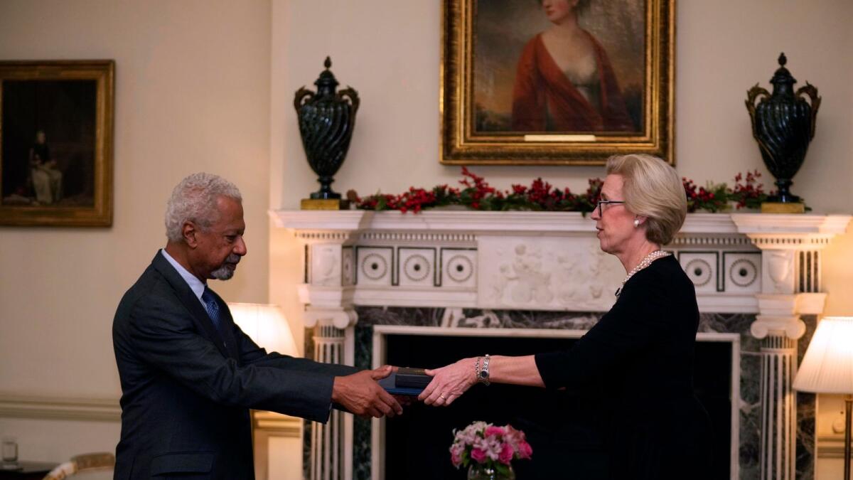 Abdulrazak Gurnah is presented with the 2021 Nobel Prize for Literature by the Ambassador of Sweden Mikaela Kumlin Granit, during a ceremony at the Swedish Ambassador's Residence in London. – AP