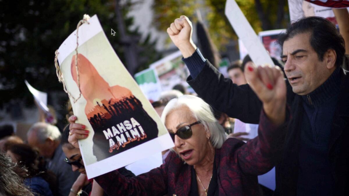 People take part in a demonstration in support of Iranian protesters in Paris. — AFP