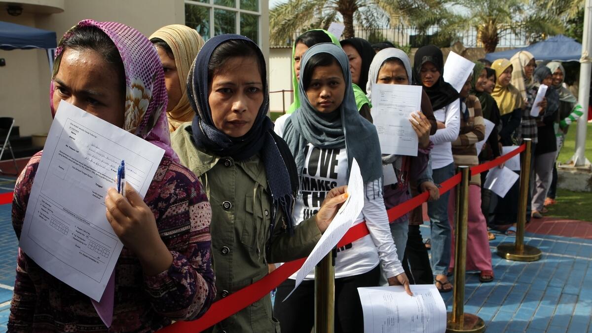 Amnesty seekers stand in a queue to submit their applications for a outpass at the Indonesian Consulate in Dubai.-File photo