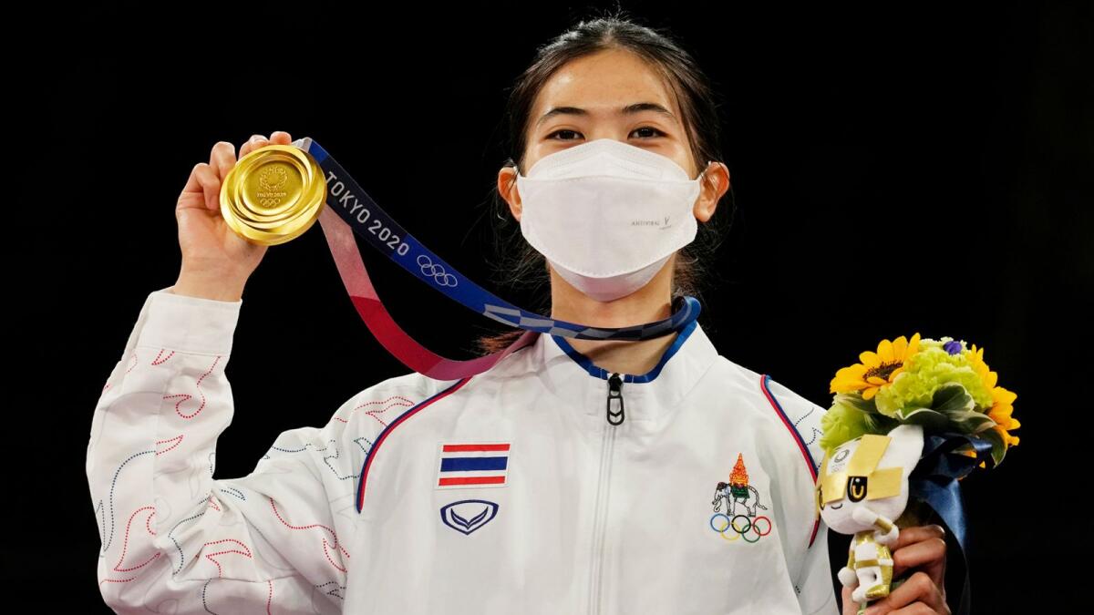Thailand's Panipak Wongpattanakit holds a gold medal during medal ceremony for the women's 49kg taekwondo at the 2020 Summer Olympics. — AP