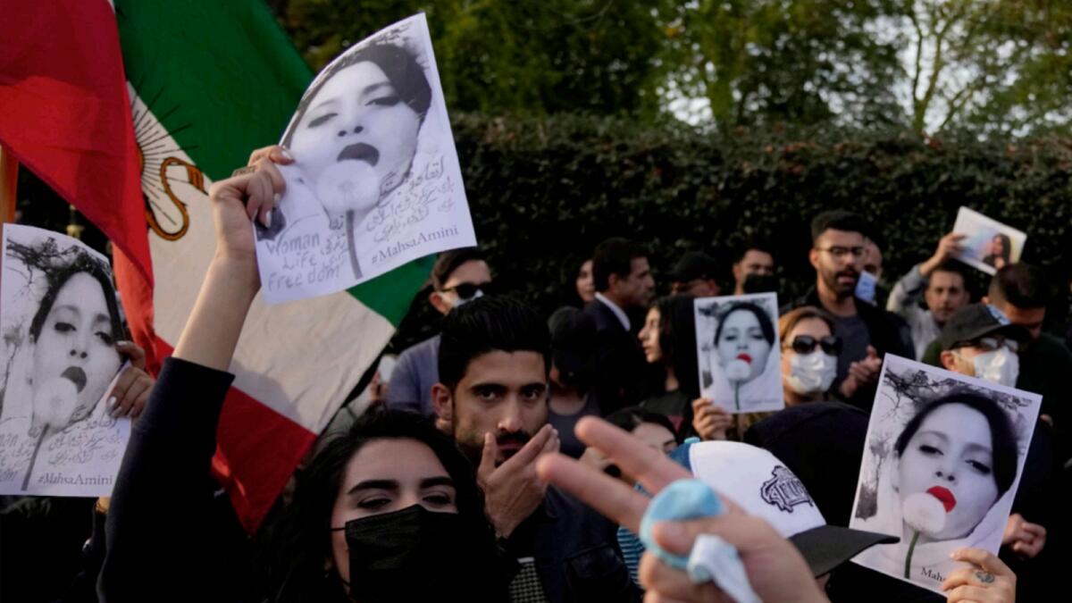 Demonstrators hold placards outside the Iranian Embassy in London in protest against the death of Mahsa Amini. — AP