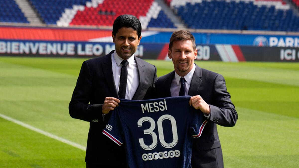 Lionel Messi displays his PSG jersey along with club president Nasser Al Khelaifi at the Parc des Princes stadium in Paris. — AP