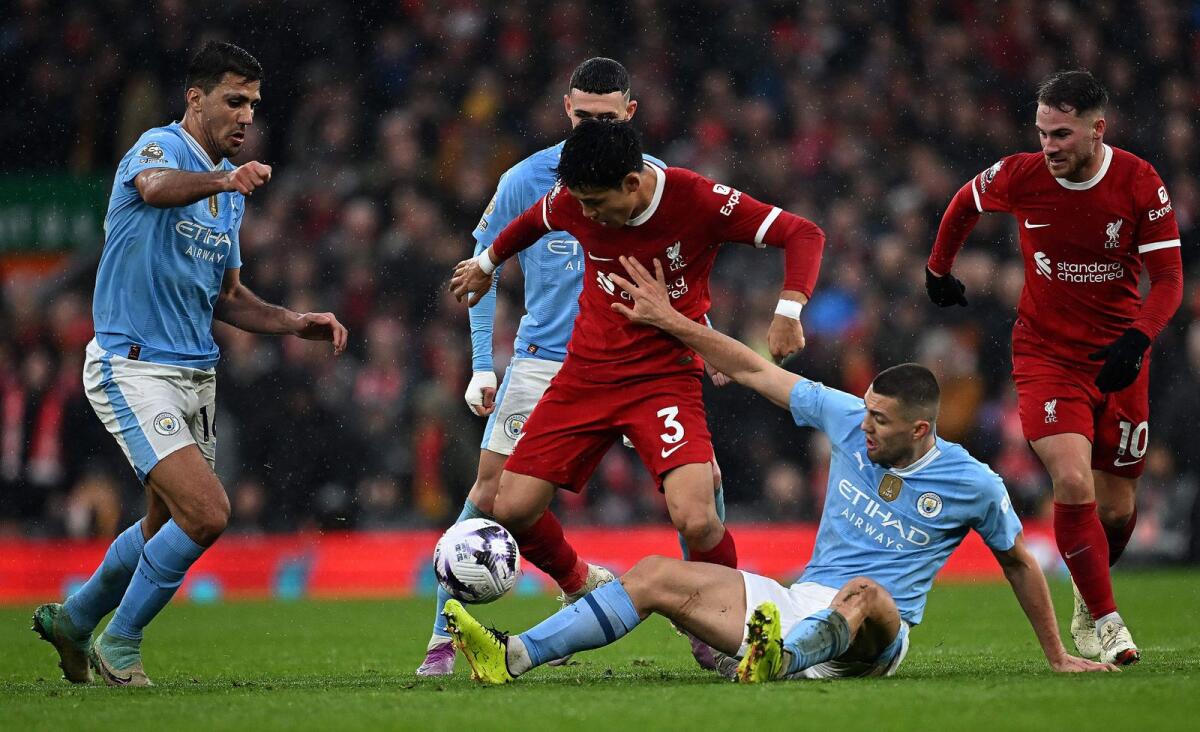 Manchester City's Croatian midfielder Mateo Kovacic (2R) vies with Liverpool's Japanese midfielder Wataru Endo (C) during the English Premier League at Anfield in Liverpool, on Sunday. - Reuters