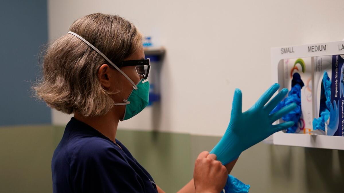 Registered nurse Sandra Younan wears a new pair of gloves at the emergency room of Providence Cedars-Sinai Tarzana Medical Center in the Tarzana neighbourhood of Los Angeles on March 10.