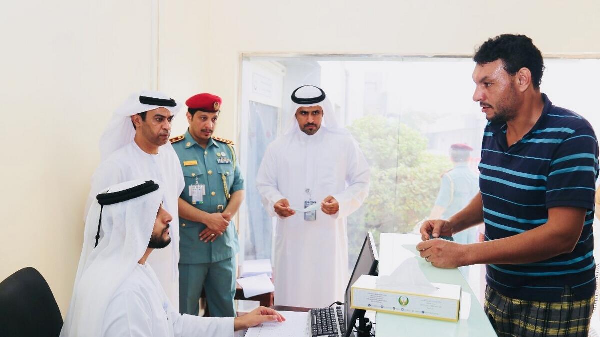 Brigadier Sultan checking the application of one of the illegal residents in Ras Al Khaimah.- Supplied photo