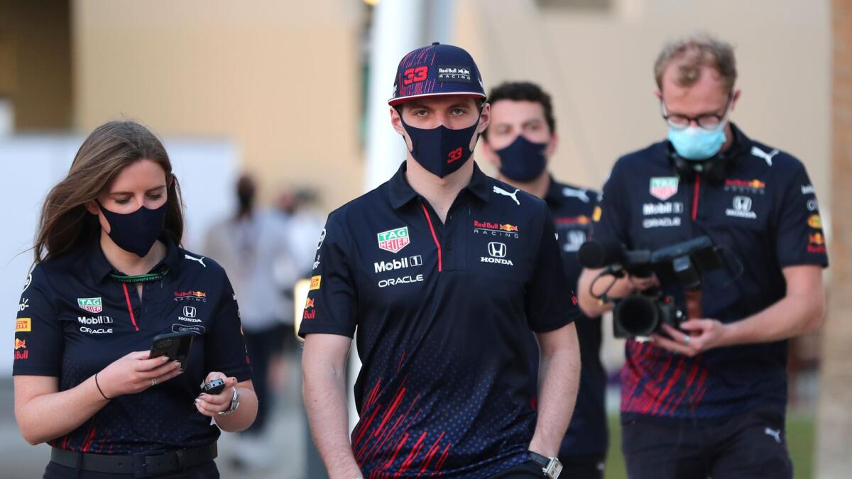 Red Bull driver Max Verstappen (centre) of the Netherlands arrives at the Yas Marina racetrack in Abu Dhabi on Thursday. (AP)