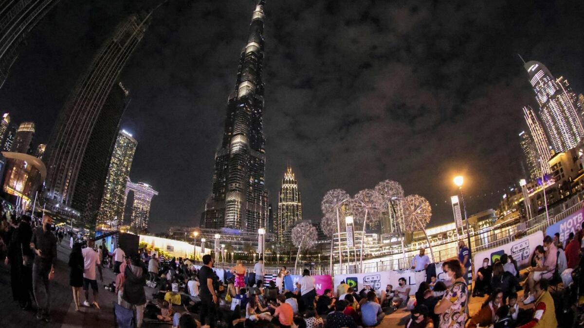 People awaiting the New Year's Eve fireworks show below Burj Khalifa in Dubai on December 31, 2021.  (Photo: AFP)