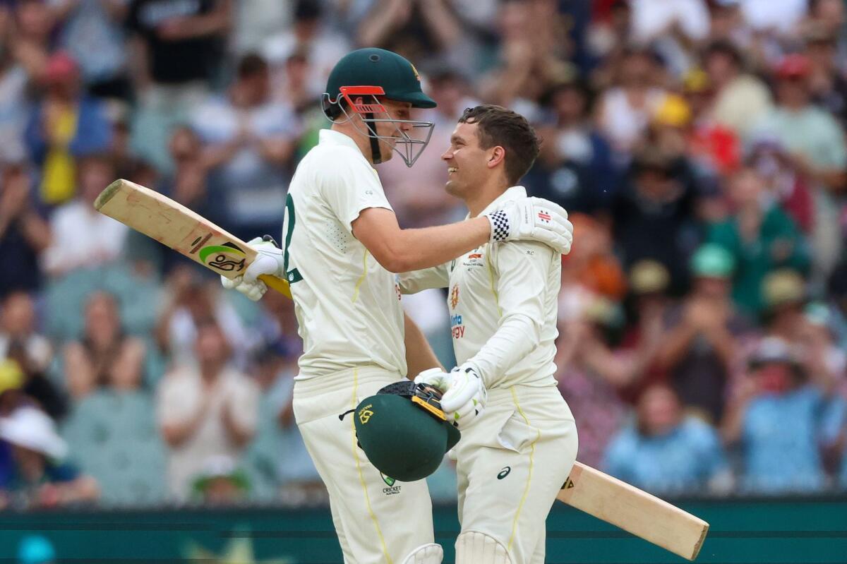 Australia's Alex Carey (right) celebrates with his teammate Cameron Green (left) after reaching his century. — AP