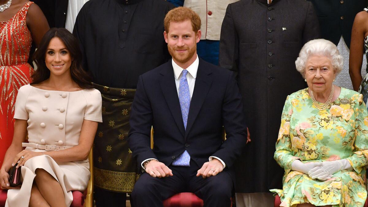 Prince Harry, with wife Meghan and Queen Elizabeth II. Photo: AFP