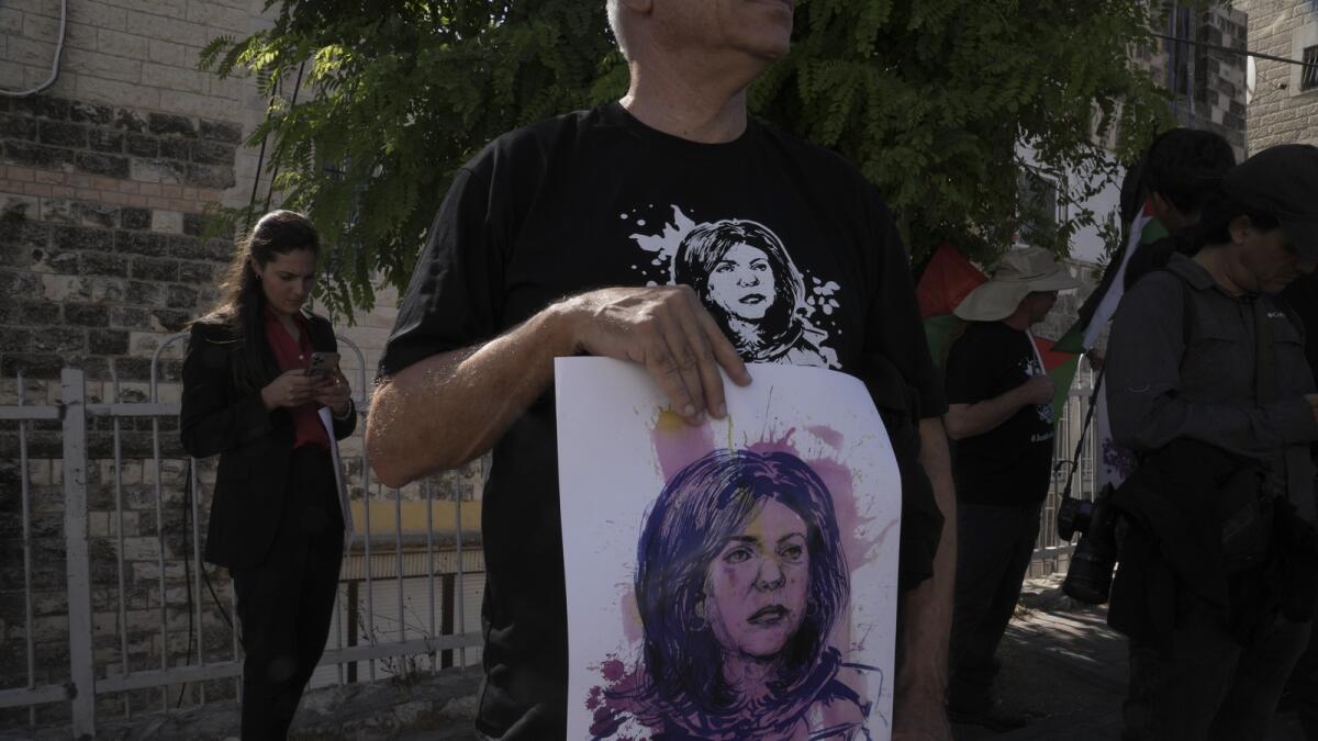 Protesters hold posters for slain Palestinian-American journalist Shireen Abu Akleh near the Augusta Victoria Hospital in east Jerusalem ahead of a visit by US President Joe Biden on July 15, 2022. — AP file