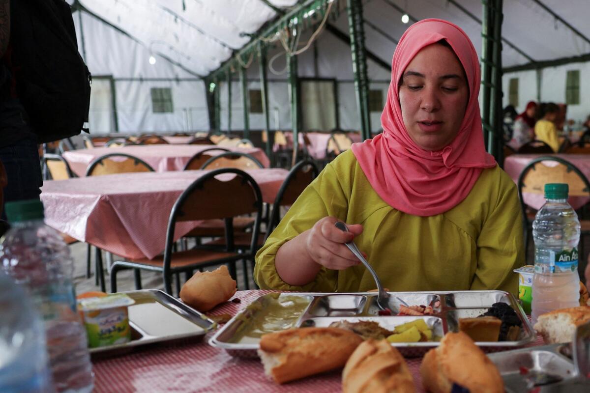 Majida Kina, a displaced quake survivor eats her meal at a military camp, following the deadly earthquake in Amizmiz, Morocco, on Sunday. — Reuters