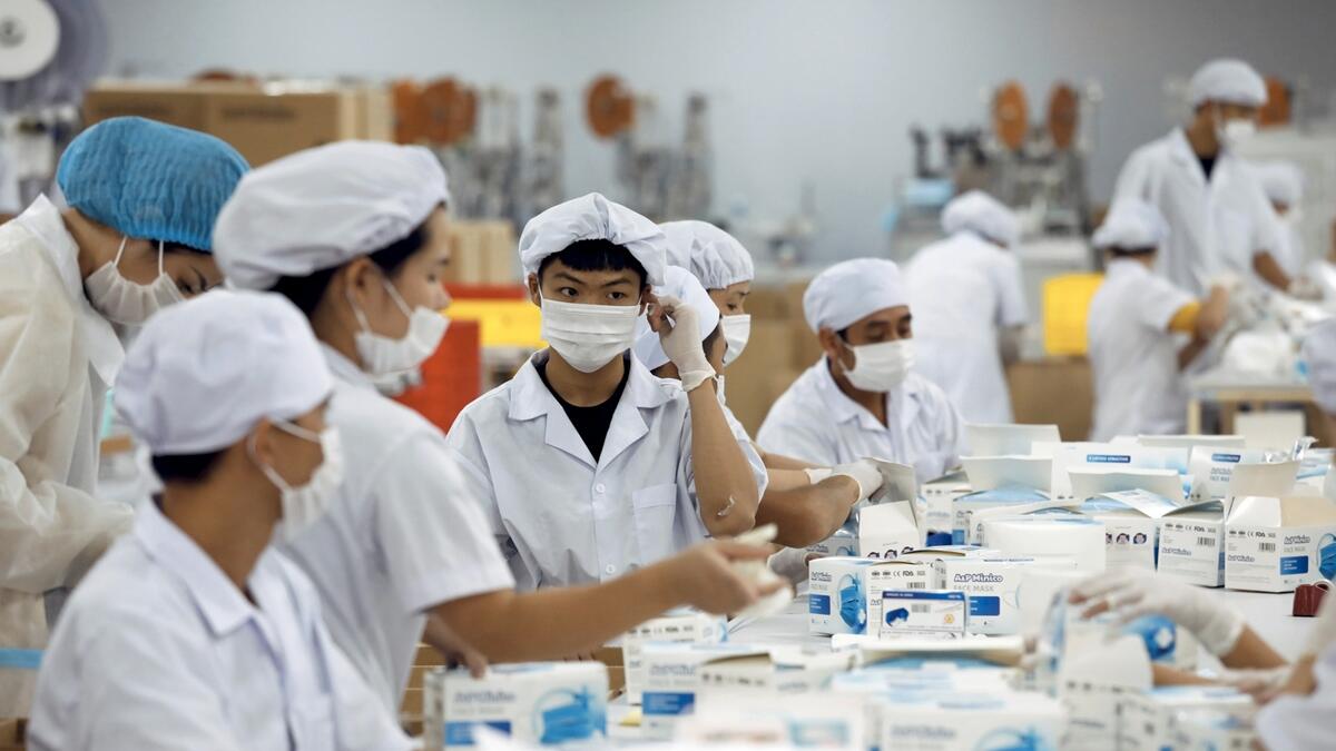Workers make medical protective masks at An Phu company's production facility for domestic and international markets, amid the spread of the coronavirus disease (Covid-19), in Bac Ninh province, Vietnam. Photo: Reuters