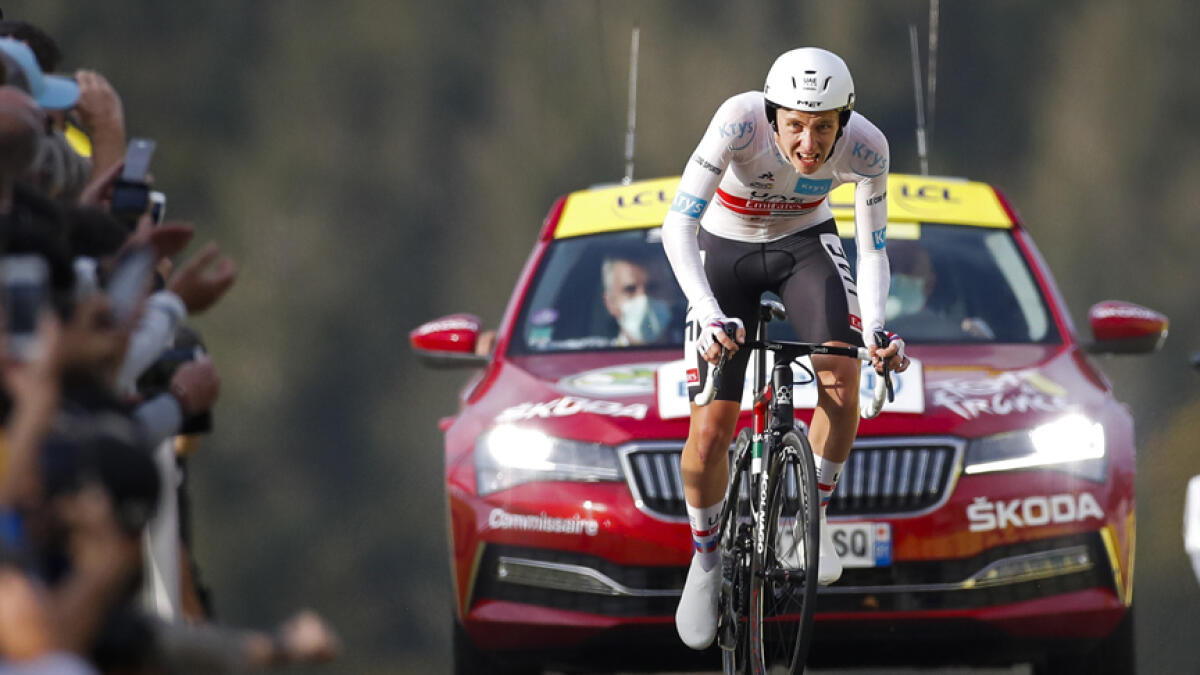 UAE Team Emirates' Tadej Pogacar wins and takes the overall leader's yellow jersey as he crosses the finish line of stage 20 of the Tour de France cycling race on Saturday. - AP