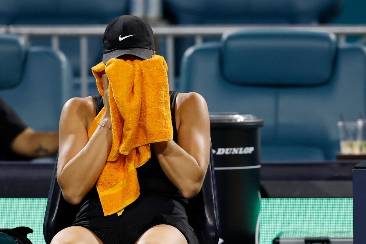 Aryna Sabalenka wipes her face after winning the second set against Anhelina Kalinina. — Reuters
