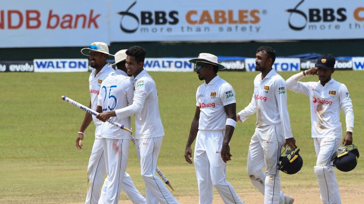 Sri Lanka's Praveen Jayawickrama (second left) and teammates celebrate after their victory in the second Test against Bangladesh. (AFP)