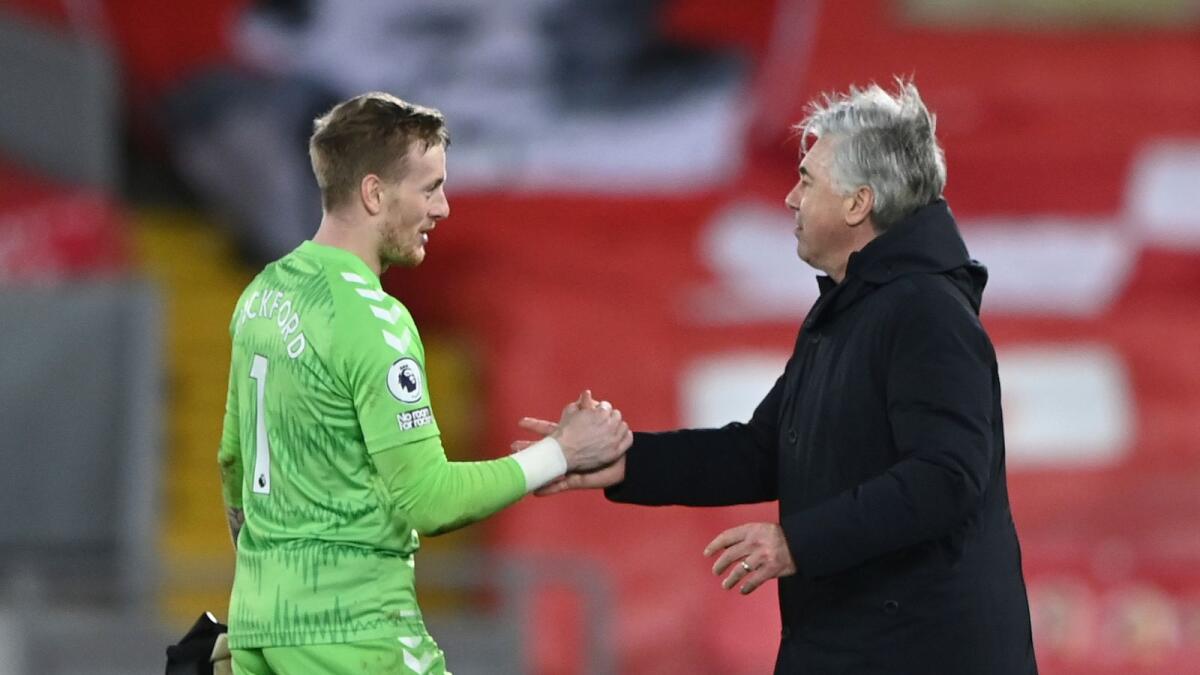 Everton's manager Carlo Ancelotti shakes hands with Everton's goalkeeper Jordan Pickford after the end of the English Premier League soccer match against Liverpool. — AP