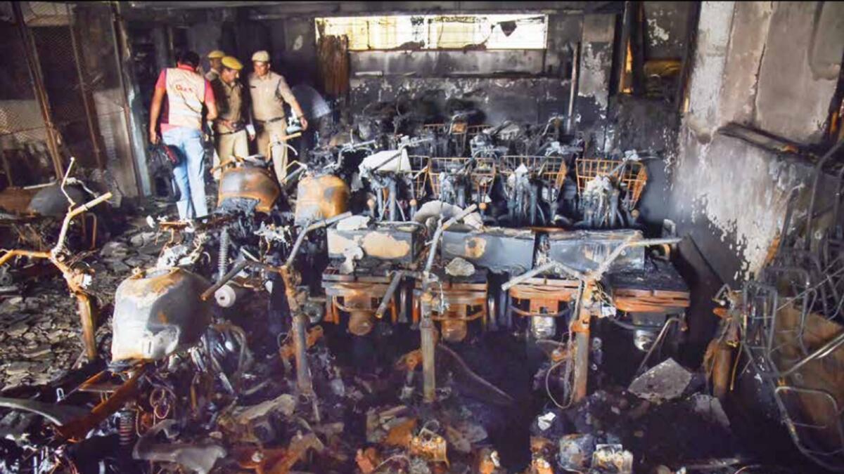 Hyderabad Police and members of their Clues team at the site on Tuesday after a fire broke out in an electric bike showroom in Secundrabad on Monday. Photo: PTI