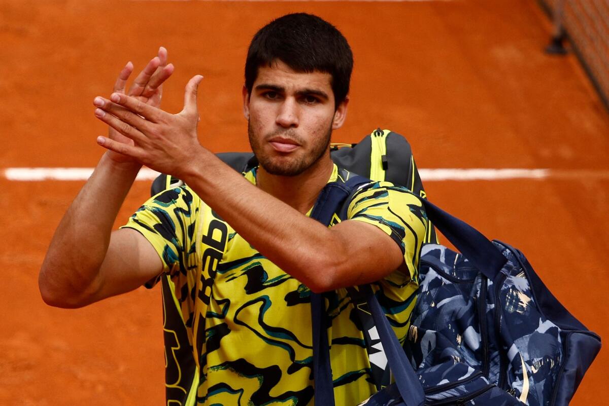 Spain's Carlos Alcaraz applauds fans after losing his round of 32 match against Hungary's Fabian Marozsan in the Italian Open on Monday.. — Reuters
