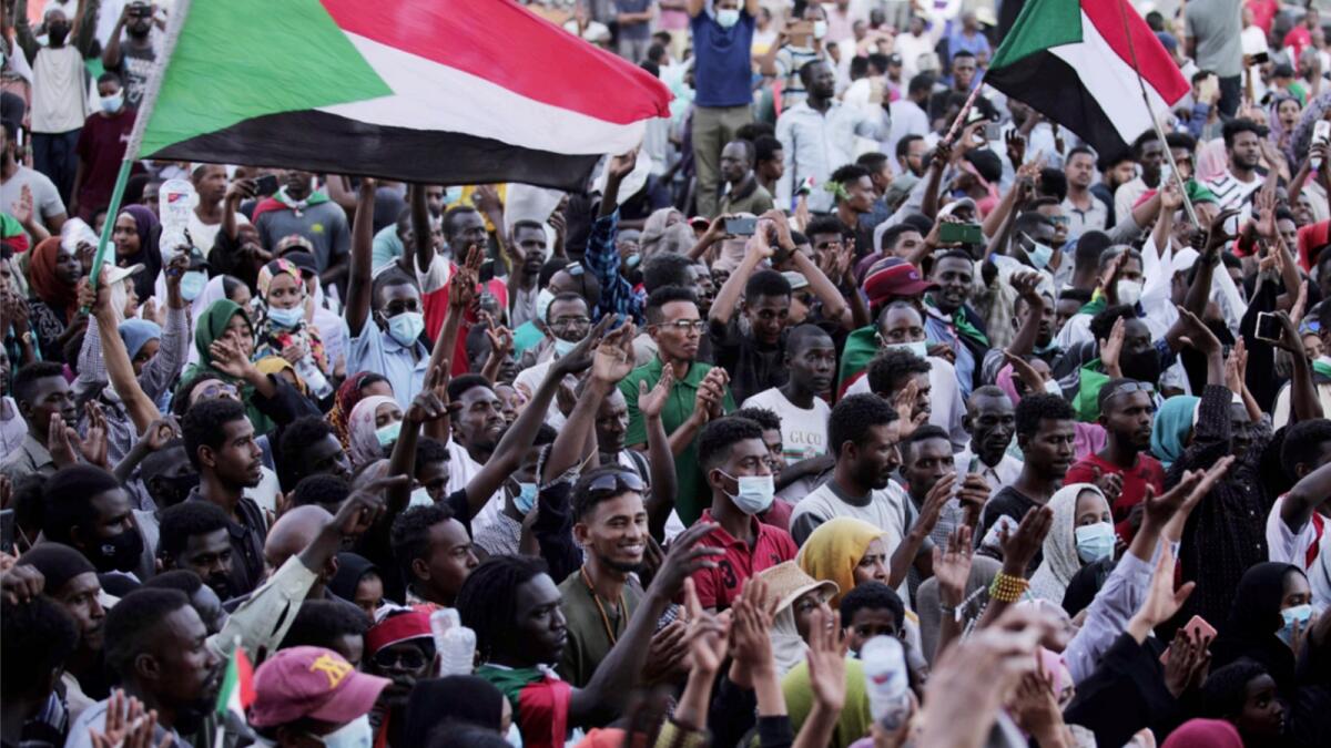 People chant slogans during a protest in Khartoum. — AP
