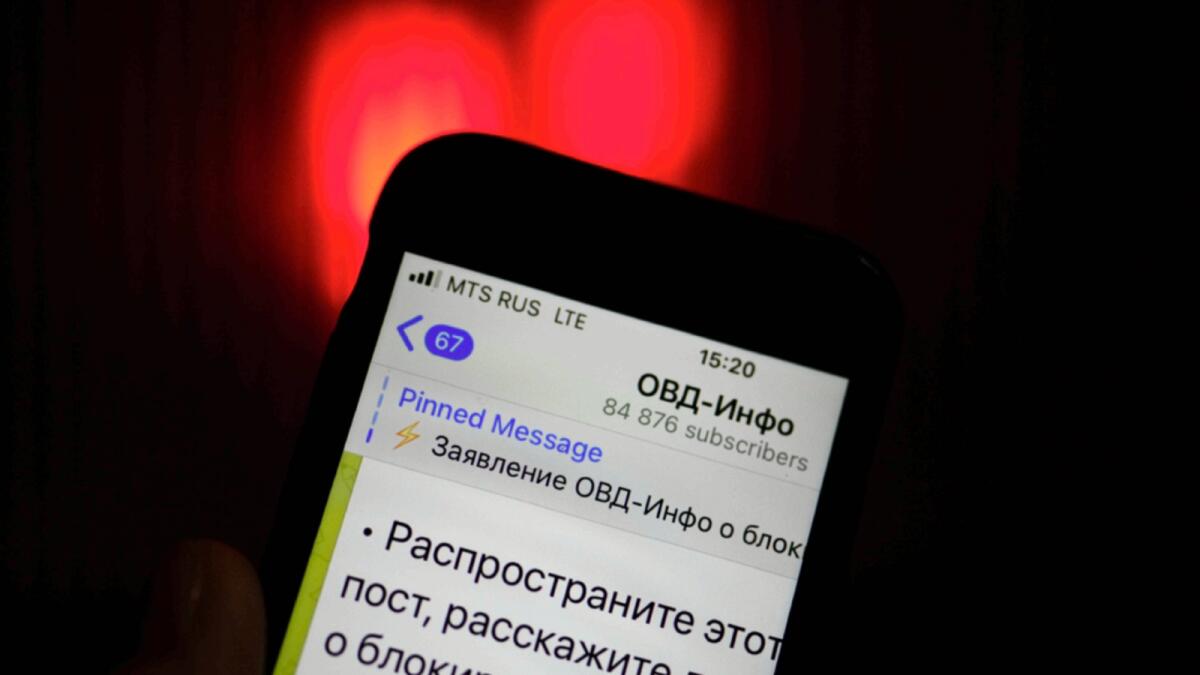 An iPhone screen shows a Telegram account of OVD-Info, prominent legal aid group in Russia that tracks political arrests in Moscow. — AP